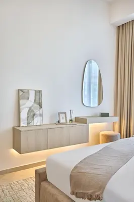 a hotel room with a bed and a mirror at Stylish 1BR Retreat in JVC Modern & Cozy Stay in Dubai