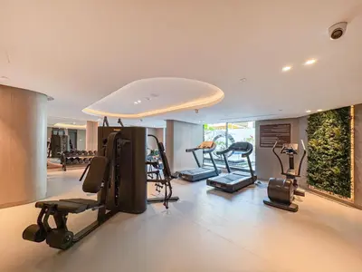 a gym with several exercise equipment in a room at Stylish Studio Retreat Modern Stay in JVC in Dubai