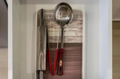 a group of utensils sitting on top of a door at Modern Meydan Studio Burj View Downtown in Dubai