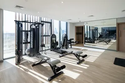a gym with treadmills and cardio equipment in a building at Modern Meydan Studio Burj View Downtown in Dubai