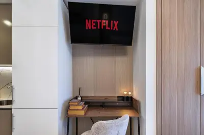 a television hanging on a wall in a room at Luxury Meydan Studio Near Dubai Mall & Downtown in Dubai