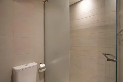 a bathroom with a toilet and a shower at Luxury Meydan Studio Near Dubai Mall & Downtown in Dubai