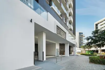 an external view of a white building with a sidewalk at Luxury Meydan Studio Near Dubai Mall & Downtown in Dubai