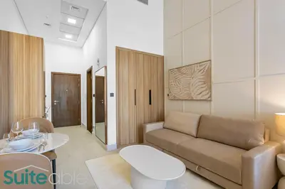 a living room with a couch and a table at Luxe Interior Studio in Pantheon Elysee 3 in JVC in Dubai