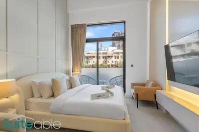 a hotel room with a bed and a tv at Luxe Interior Studio in Pantheon Elysee 3 in JVC in Dubai