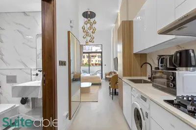 a kitchen with a sink and a counter top at Luxe Interior Studio in Pantheon Elysee 3 in JVC in Dubai