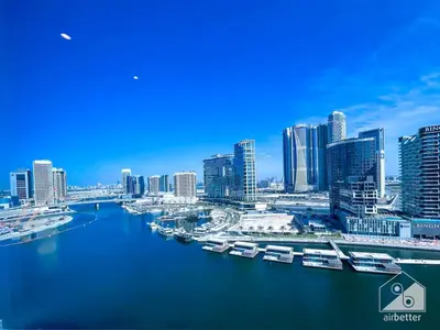 a view of a city with boats in the water at Luxury Studio in Business Bay with Canal View in Dubai
