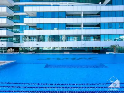 a swimming pool in front of a building at Luxury Studio in Business Bay with Canal View in Dubai
