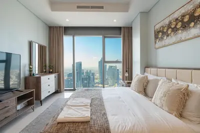 a bedroom with a large bed and a large window at Near Dubai Mall - Pool Access - Sun Set View - KingBed in Dubai