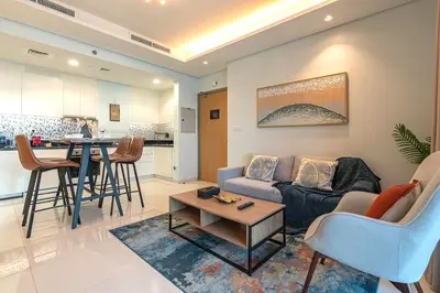 a living room with a couch and a table at Near Dubai Mall - Pool Access - Sun Set View - KingBed in Dubai