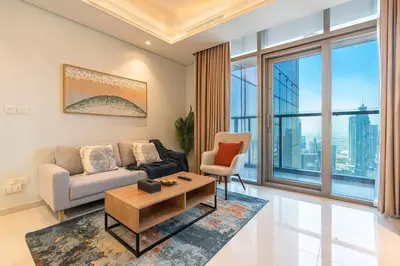 a living room with a couch and a table at Near Dubai Mall - Pool Access - Sun Set View - KingBed in Dubai