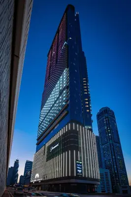 a tall building with the american flag on it at Near Dubai Mall - Pool Access - Sun Set View - KingBed in Dubai