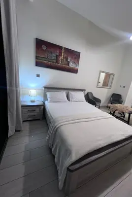 a bedroom with a large white bed with white sheets at Studios Apartment in Azizi Riviera in Dubai