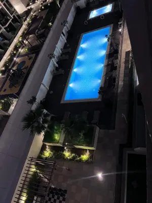 a large window on the side of a building with plants at Studios Apartment in Azizi Riviera in Dubai