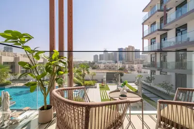 an apartment balcony with a view of the city at Exquisitely designed studio in Oxford terraces JVC in Dubai