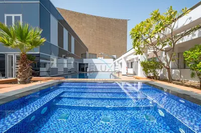 an image of a swimming pool in a villa at City-Centered 1BR, Minutes to Metro and Key Attractions, Sky Gardens, DIFC by Deluxe Holiday Homes in Dubai
