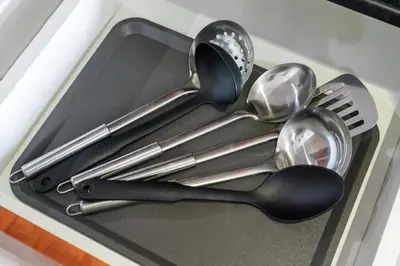 a tray filled with utensils in a drawer at Stylish JLT Studio Lakeview Metro 5min & Marin in Dubai