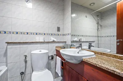 a bathroom with a toilet and a sink at Stylish JLT Studio Lakeview Metro 5min & Marin in Dubai
