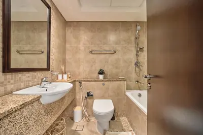 a bathroom with a toilet and a sink and a tub at Chic Studio in Sky Gardens, DIFC Prime Location in Dubai