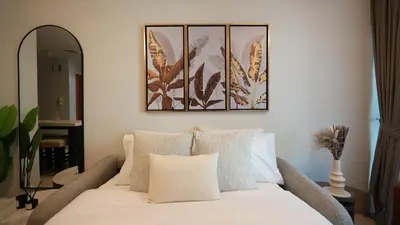 a living room with a white couch and a mirror at 1BHK full canal view apartment in Business bay ! in Dubai