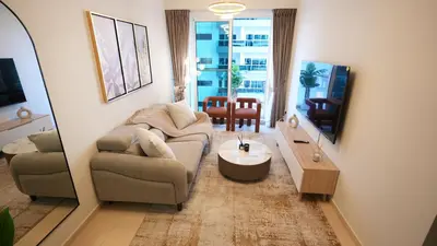 a living room with a couch and a table at 1BHK full canal view apartment in Business bay ! in Dubai