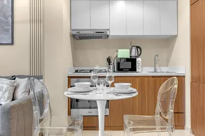 a small kitchen with a white table and chairs at City View 1BR Prime Location in Business Bay by Vibel in Dubai