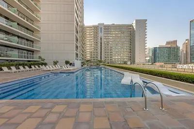 a swimming pool on the roof of a building at City View 1BR Prime Location in Business Bay by Vibel in Dubai