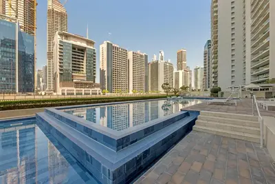 a swimming pool in a city with tall buildings at City View 1BR Prime Location in Business Bay by Vibel in Dubai