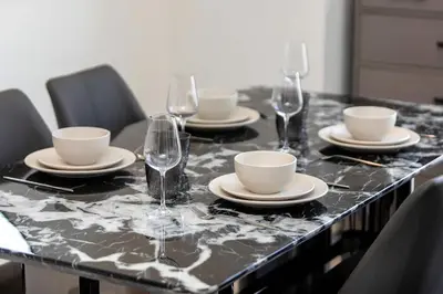 a table with plates and wine glasses on it at High-Rise 1BR Apartment with Burj Khalifa view in Dubai