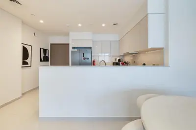 a kitchen with white walls and a white counter top at ALiving Elite 3BR Apartment I Burj Khalifa & Fountain View I Burj Royale in Dubai