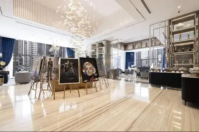 a room with paintings on display in a building at Stylish 2BR Apt in 5 Star Hotel with Burj Khalifa Views in Dubai