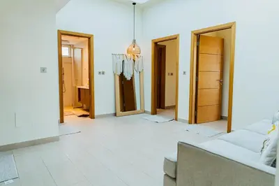 a living room with a couch and several doors at Stunning 4BR Jumeira Park Villa With Pool and Jacuzzi in Dubai