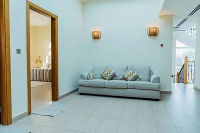 a living room with a couch and a mirror at Stunning 4BR Jumeira Park Villa With Pool and Jacuzzi in Dubai