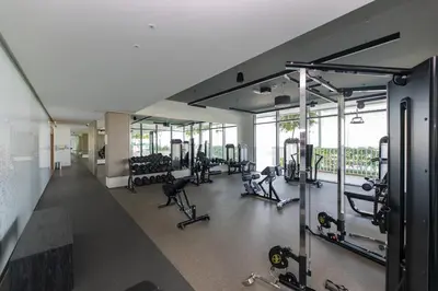 a gym with lots of treadmills and machines at Luxury 2BR Apt with Pool, Gym & Sea Views in Dubai