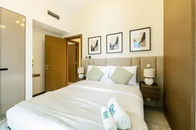 a bedroom with a large white bed with two pillows at FAM Living - 3 bedroom and Maids Room Retreat Overlooking Dubai Canal in Dubai
