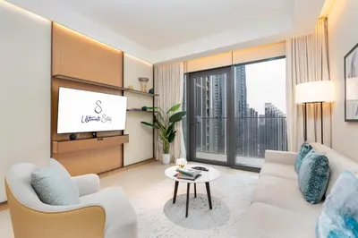 a living room with a couch and a tv at Ultimate Stay Luxurious Address Opera 2BR Next to Burj Khalifa and Dubai Mall Large Balcony with Stunning Views in Dubai