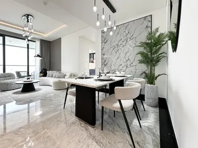 a living room with a dining table and chairs at Trophy-Lux 1BR Jacuzzi Suite Busbay W Big Balcony in Dubai