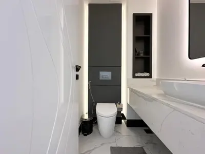 a white bathroom with a toilet and a sink at Trophy-Lux 1BR Jacuzzi Suite Busbay W Big Balcony in Dubai
