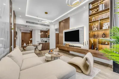 a living room with white furniture and a flat screen tv at Burj Khalifa & Canal Views at Mayfair Tower in business bay - Luxurious 1BDR Apartment in Dubai