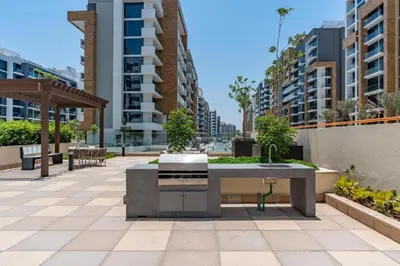 a patio with a fountain in the middle of a city at Community View Studio with Balcony, Azizi Riviera 24, Al Merkadh by Deluxe Holiday Homes in Dubai