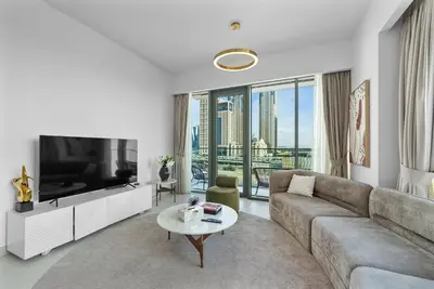 a living room with a couch and a tv at Magnificent - New 1BR in Canal Front Residences in Dubai