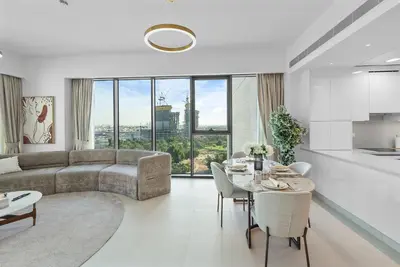 a living room with a couch and a table at Magnificent - New 1BR in Canal Front Residences in Dubai