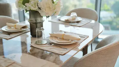 a wooden table with plates and a vase with flowers at Magnificent - New 1BR in Canal Front Residences in Dubai