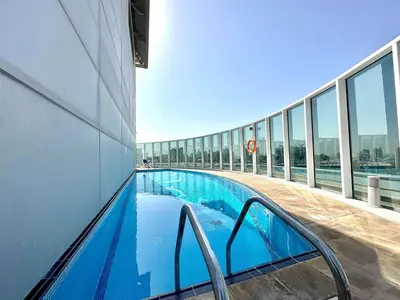 a swimming pool on the side of a building at Silkhaus Chic Studio at Barsha Heights in Madison in Dubai