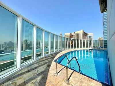 a balcony with a swimming pool on a building at Silkhaus Chic Studio at Barsha Heights in Madison in Dubai