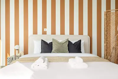 a bedroom with a bed with two towels on it at Silkhaus Cozy Studio at Madison in Barsha Heights in Dubai