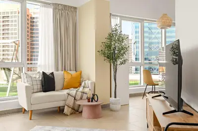 a living room with a couch and a tv at Silkhaus Large Studio in Madison near Barsha Heights in Dubai