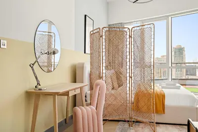 a bedroom with a mirror and a desk and a bed at Silkhaus Large Studio in Madison near Barsha Heights in Dubai
