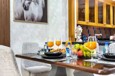 a table with fruit and glasses of orange juice at Stylish 2-Bedroom in the Heart of OldTown Dubai in Dubai