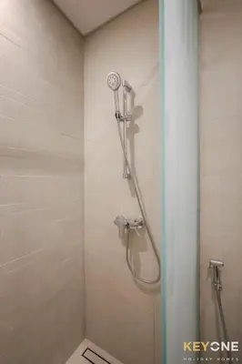 a shower with a shower head in a bathroom at Modern Elegance Studio in Azizi Riviera in Dubai
